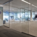 Full glass sliding door in al single glass system wall