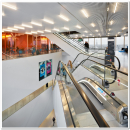 Escalators with in the back partition wall with film of QbiQ