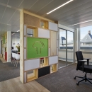 Circular office wall made of reused materials.