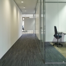Office wall made of single glass with acoustic foil in between