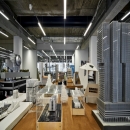 Room full with models and a partition wall in the back of QbiQ