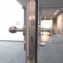 Lock and doorhandle in a fire resistant framed door EW30