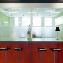 Coffee corner with in the back a IQ-Structural double glass partition wall without vertical stands.