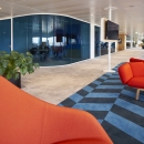 Blue curved glasss for round corners in a double glass partition wall