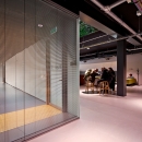 Corner of a glass partition walls with enforced door frames.