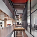Corridor with extra high glass partition wall at a vide