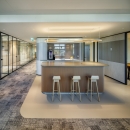 Glass partitions with black profiles, door handles hinges and locks.
