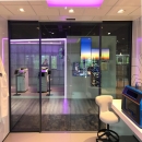 Electronic sliding doors in an IQ-Structural partition glass wall