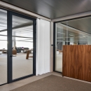 Glass partition with black profiles.