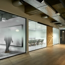 Offices with barn doors and glass partitions.