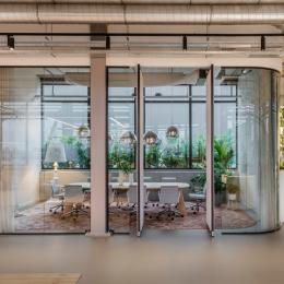 a meeting room with curved glass 