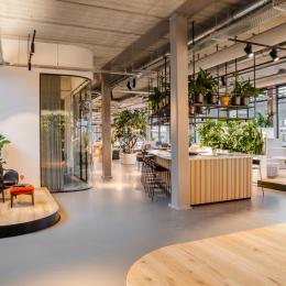 A meeting room in the background with curved glass