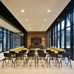 Within a meeting room with glass partition walls of QbiQ